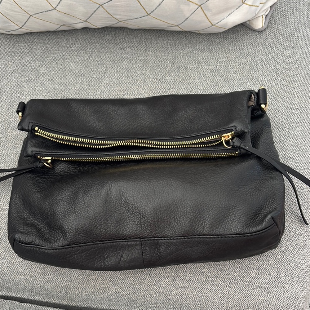 Margot New York Mickey fold-over crossbody bag in black leather.